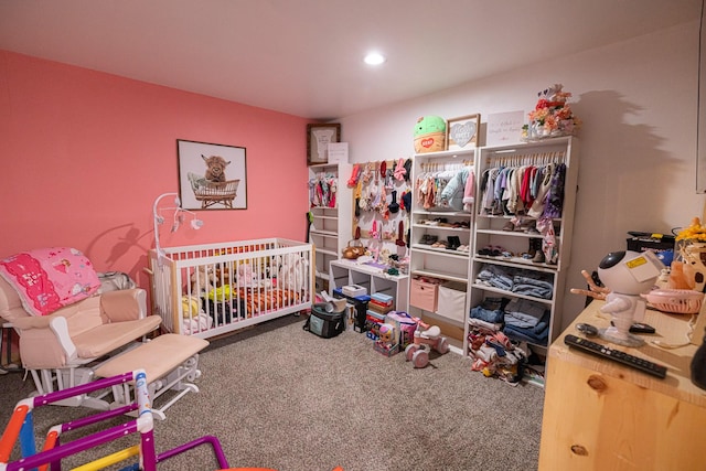 carpeted bedroom featuring a crib