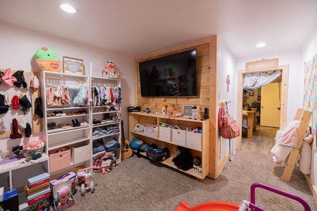 recreation room featuring light carpet