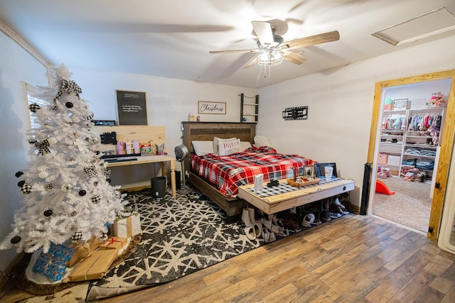 bedroom featuring ceiling fan, a closet, and wood-type flooring