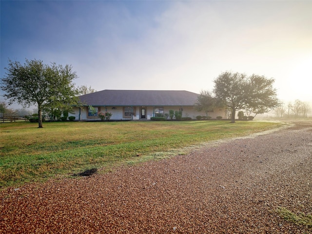 ranch-style house featuring a front lawn