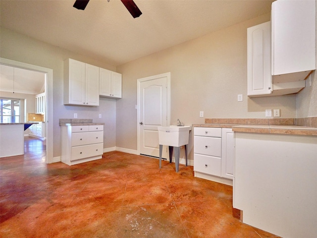 kitchen featuring white cabinetry and ceiling fan