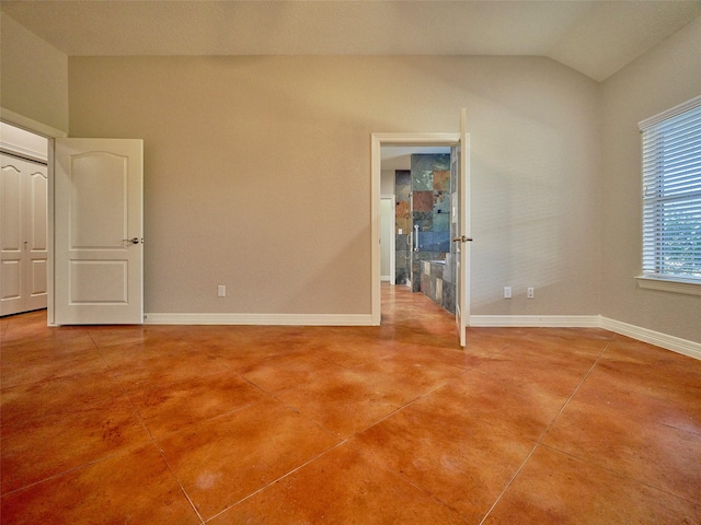 spare room with lofted ceiling