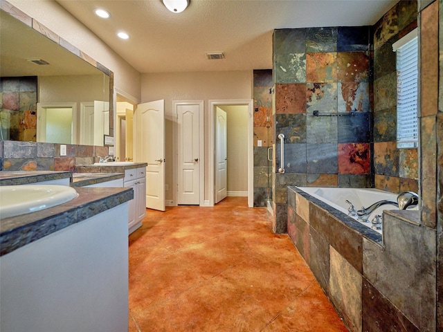 bathroom featuring a textured ceiling, vanity, and separate shower and tub