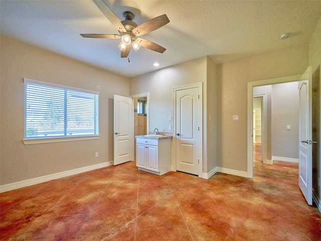 unfurnished bedroom featuring ceiling fan and sink