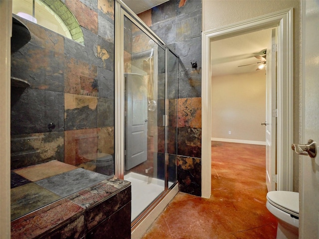 bathroom featuring ceiling fan, toilet, and walk in shower