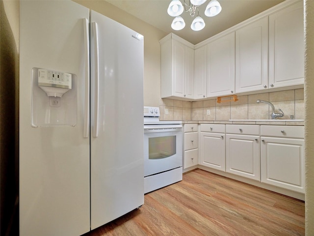 kitchen with backsplash, white cabinets, light hardwood / wood-style floors, and white appliances