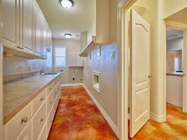 kitchen featuring tile countertops and sink