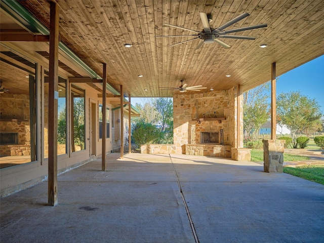 view of patio / terrace with an outdoor stone fireplace and ceiling fan