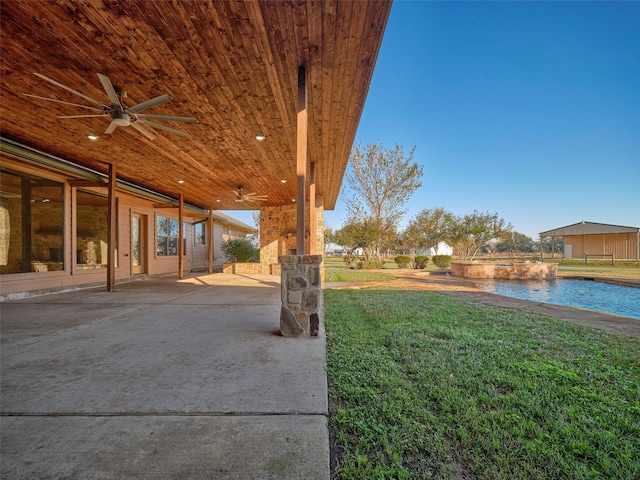 view of yard with a patio area and ceiling fan