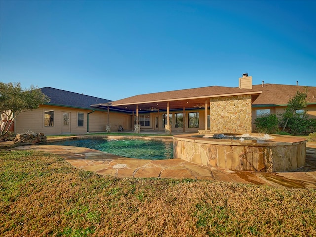 view of swimming pool featuring a hot tub