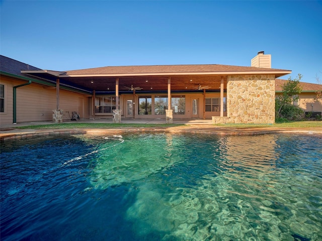 view of pool with a patio area and ceiling fan