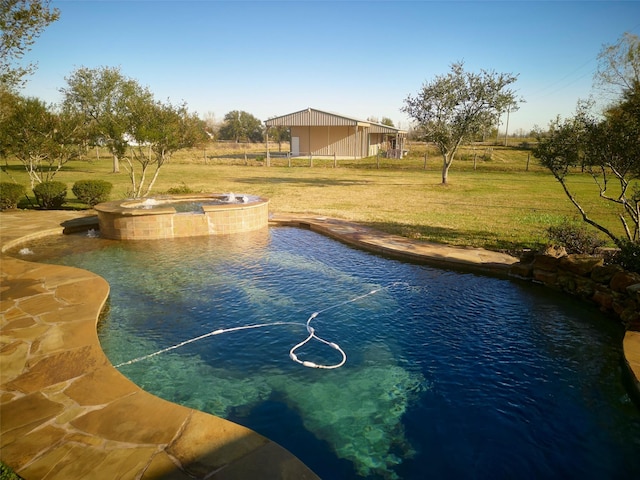 view of pool with an in ground hot tub and a yard