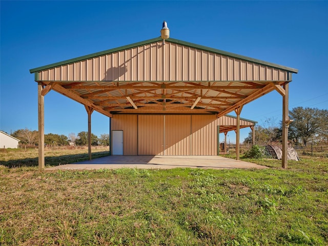 view of outdoor structure featuring a lawn