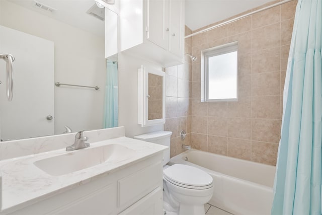 full bathroom featuring tile patterned floors, vanity, shower / bath combination with curtain, and toilet