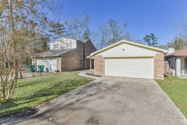 view of front of home with a front lawn and a garage