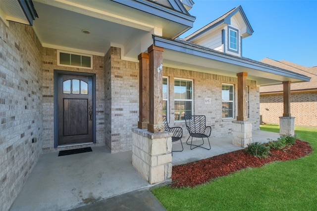 view of exterior entry with a porch