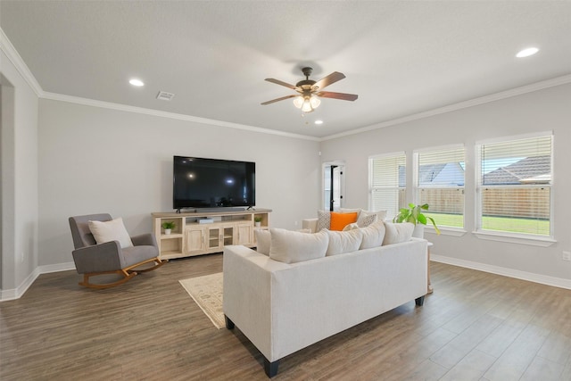 living room with ceiling fan, ornamental molding, and dark wood-type flooring