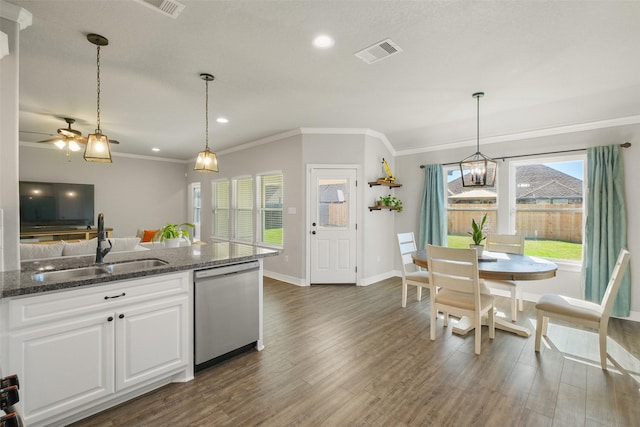 kitchen featuring pendant lighting, dishwasher, white cabinets, sink, and dark stone countertops