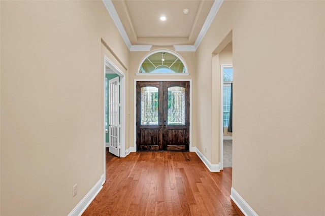 entryway featuring hardwood / wood-style flooring, crown molding, and french doors