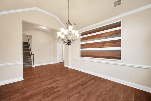 unfurnished dining area featuring dark hardwood / wood-style flooring, an inviting chandelier, vaulted ceiling, and crown molding