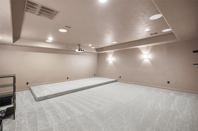 basement with light colored carpet and a textured ceiling