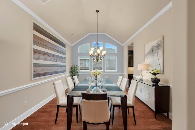 dining space featuring lofted ceiling, dark hardwood / wood-style floors, ornamental molding, and a notable chandelier