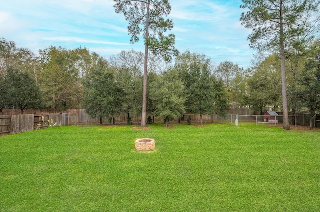 view of yard with an outdoor fire pit