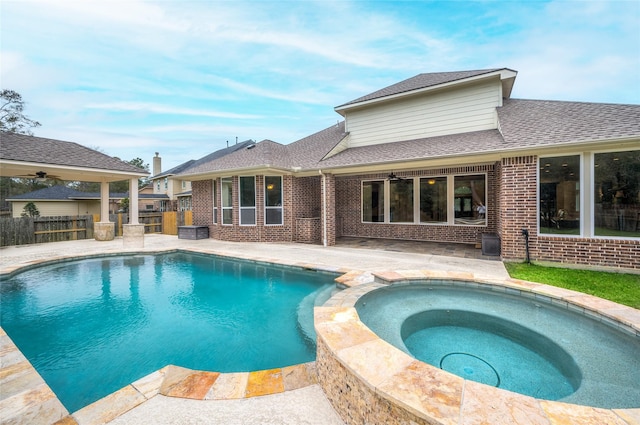 view of swimming pool with an in ground hot tub