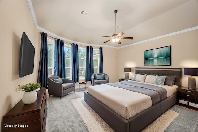 carpeted bedroom featuring ceiling fan and crown molding