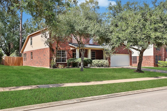 view of front of house with a garage, a front yard, brick siding, and fence