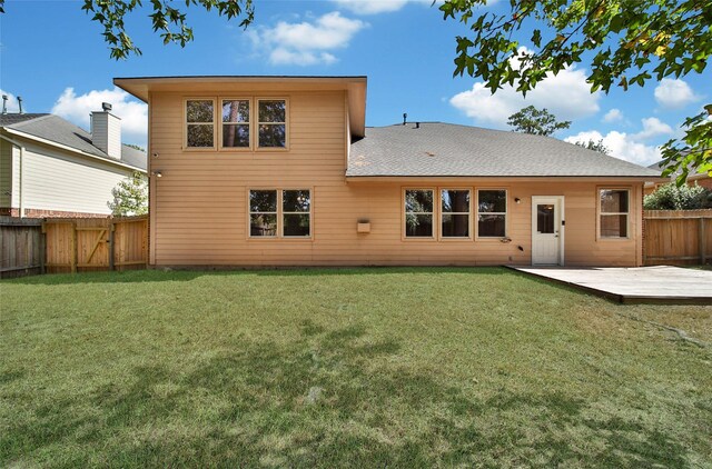 rear view of house with a lawn and a patio