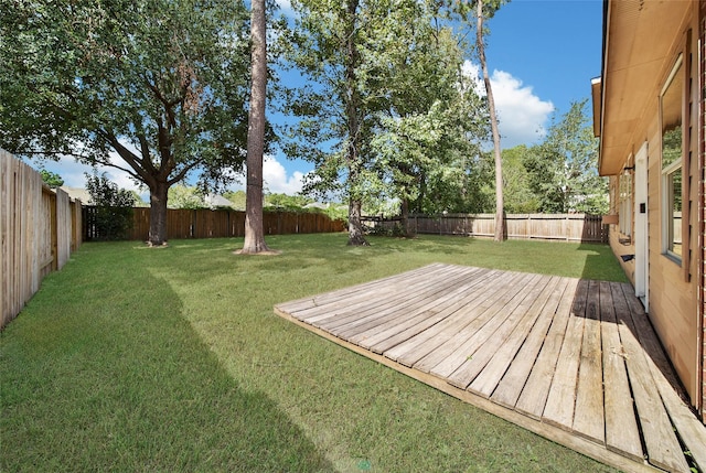 view of yard with a fenced backyard and a deck