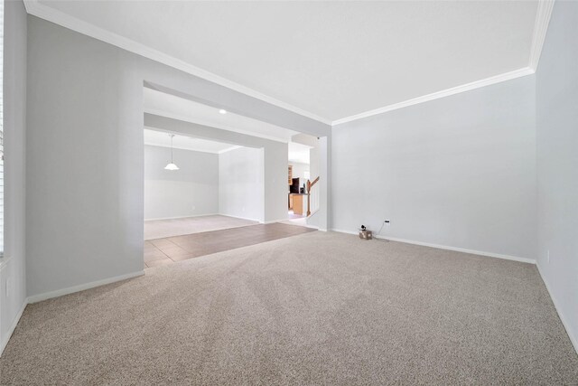 spare room with light carpet and ornamental molding