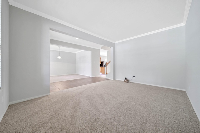 unfurnished room with light carpet, baseboards, and crown molding