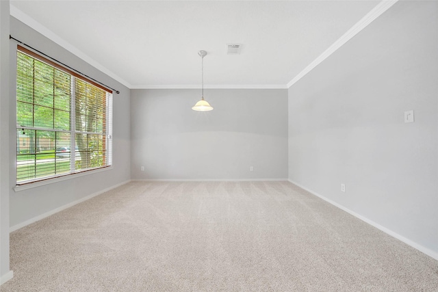 carpeted empty room featuring baseboards, visible vents, and crown molding