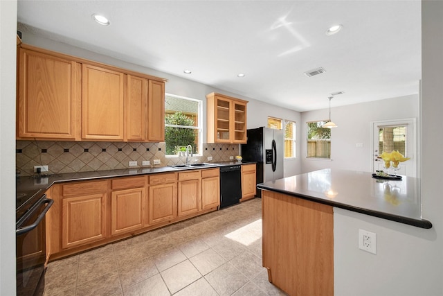 kitchen featuring sink, hanging light fixtures, stainless steel fridge, black dishwasher, and range