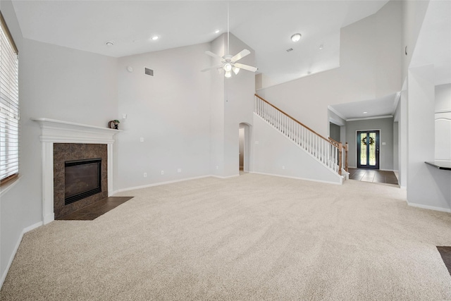 unfurnished living room featuring a fireplace, carpet, high vaulted ceiling, and a healthy amount of sunlight