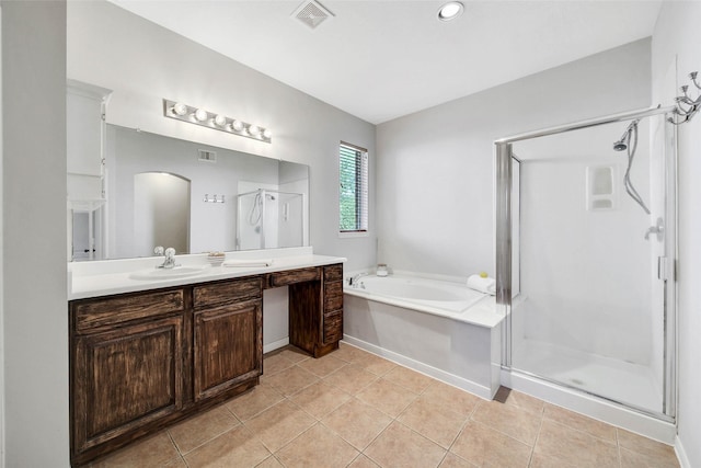 bathroom with tile patterned flooring, vanity, and shower with separate bathtub