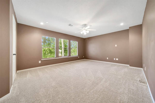 empty room with recessed lighting, visible vents, a ceiling fan, light carpet, and baseboards