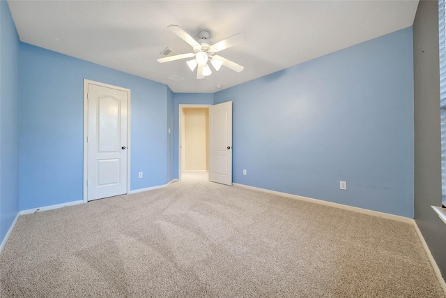 unfurnished bedroom featuring ceiling fan, carpet flooring, visible vents, and baseboards