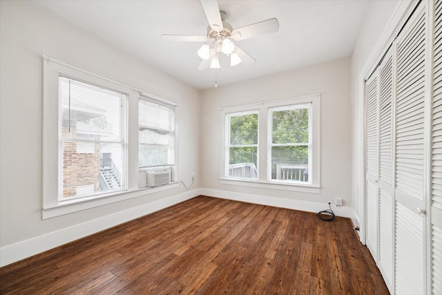 interior space with ceiling fan, dark hardwood / wood-style floors, a closet, and cooling unit