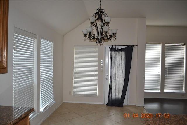 unfurnished dining area with vaulted ceiling, an inviting chandelier, plenty of natural light, and light tile patterned flooring