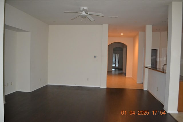 empty room featuring ceiling fan and dark hardwood / wood-style flooring