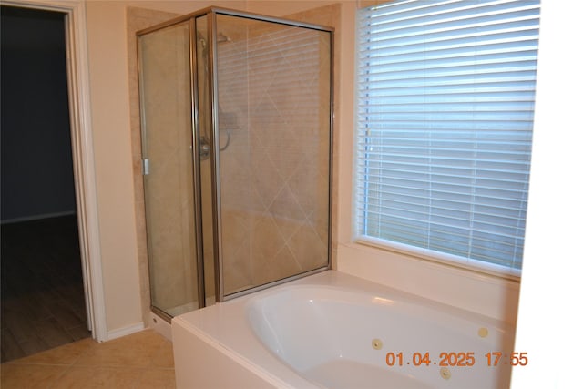 bathroom featuring tile patterned floors and shower with separate bathtub