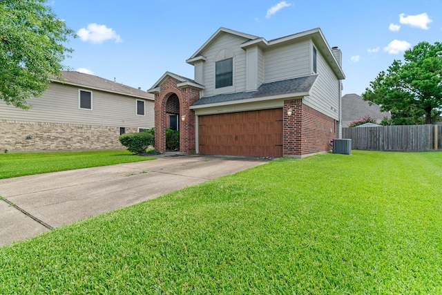 view of front of home featuring a garage, a front yard, and central AC