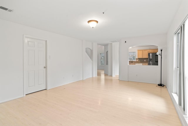 spare room with sink and light hardwood / wood-style flooring