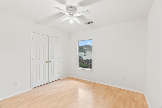 unfurnished bedroom featuring ceiling fan, a closet, and light hardwood / wood-style floors