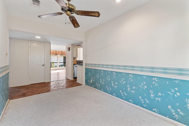 carpeted spare room with ceiling fan