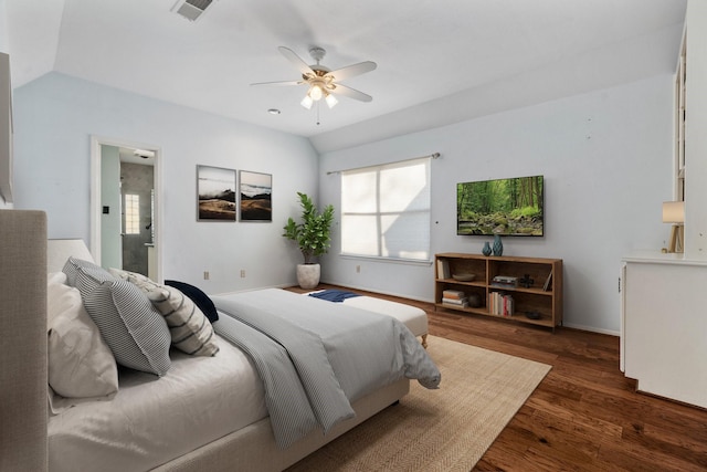 bedroom featuring dark hardwood / wood-style flooring, vaulted ceiling, ceiling fan, and connected bathroom