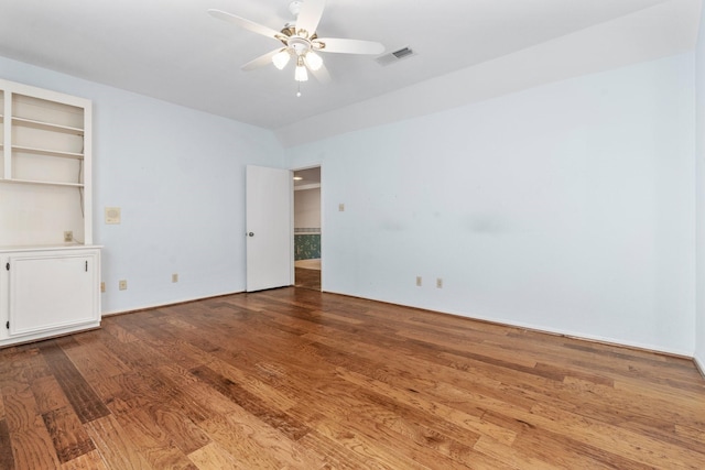 empty room with ceiling fan and light hardwood / wood-style floors